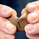 hands cracking open fortune cookie